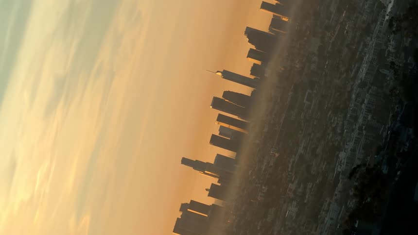 High rise building and skyscrapers in a metropolitan area covered in haze outdoors during dusk or dawn