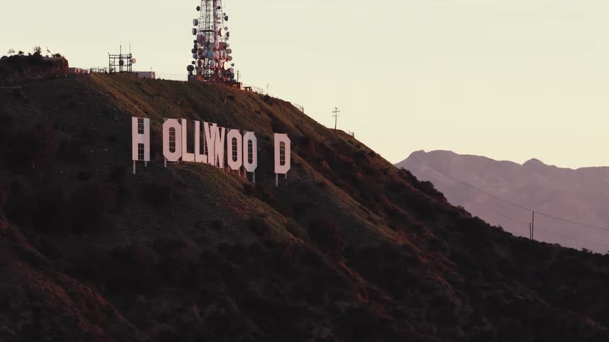 Partially visible hollywood sign with communication tower in the background