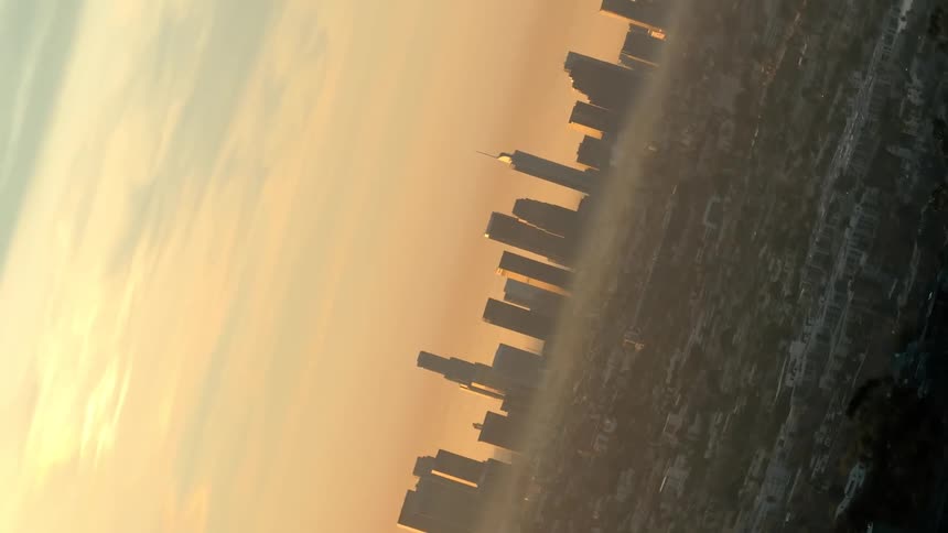 A city skyline reflects in the water