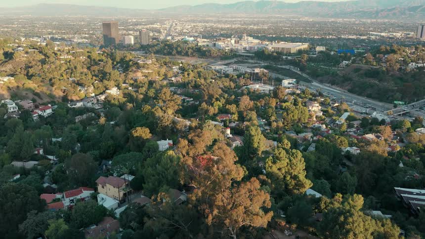 Metropolitan city surrounded by hills outdoors during day time