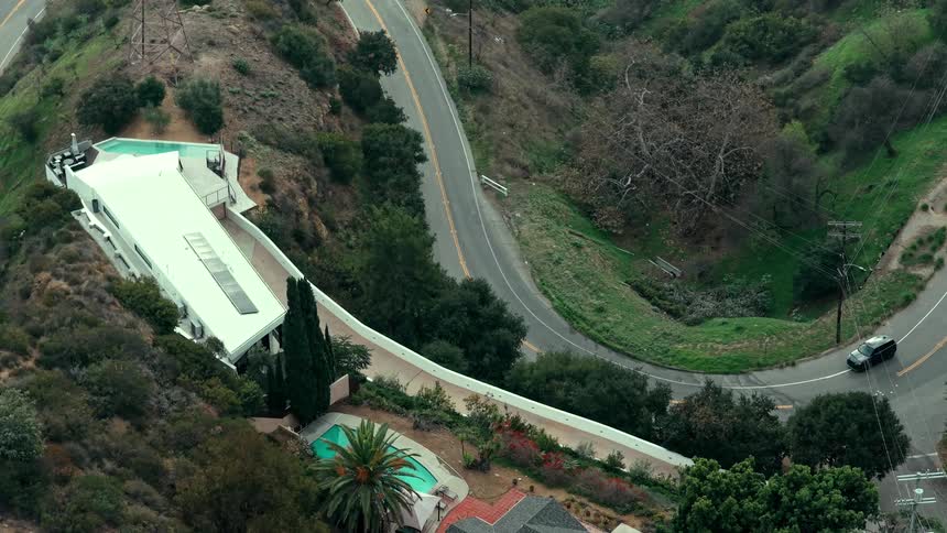 Terrace of a house on a cliff next to a road on a suburban area outdoors during day time