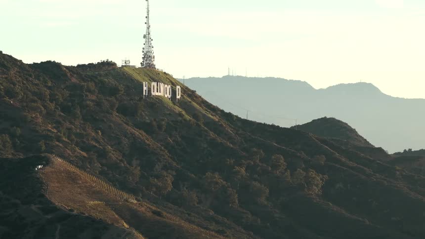 Letters spelling hollywood on a mountain with a communications tower