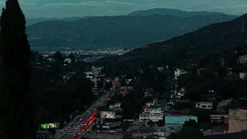 A highway runs through a mountain pass outside of a city