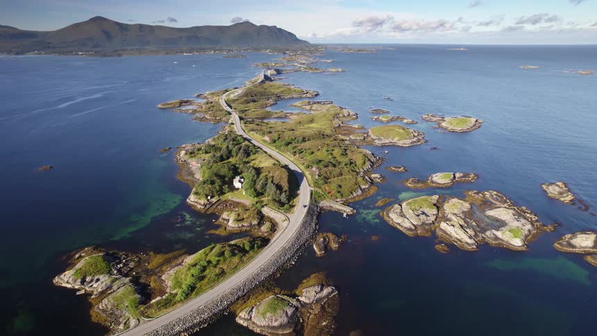 Atlantic ocean road winding through rocky islets along norways coast
