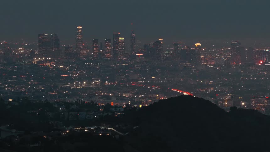 Metropolitan area next to a hill outdoors during night time