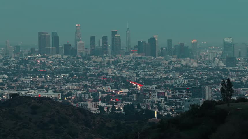 Mountains in the foreground with a metropolis in the background