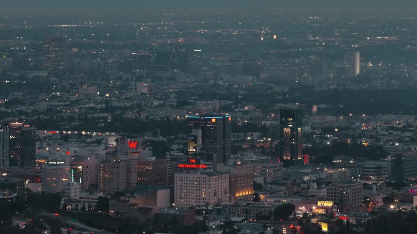 He steady linear flow of the multilane freeway that anchors the lower half of the frame showing the constant movement of commutersthe high horizontal line of the thick cloud layer that meets the hazy atmosphere creating a natural border at the top