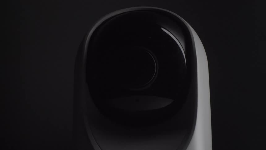 Surveillance camera with central lens in black dome over matte gray body