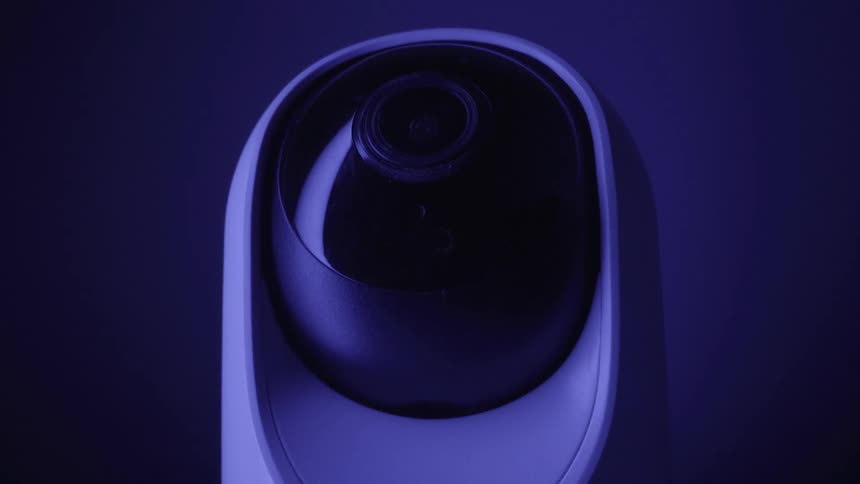 Dome surveillance camera with dark lens lit in blue
