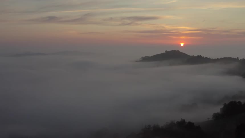 Sun rising above mistcovered valleys
