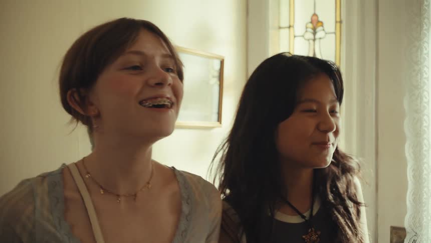 Two youths smiling near stained glass door