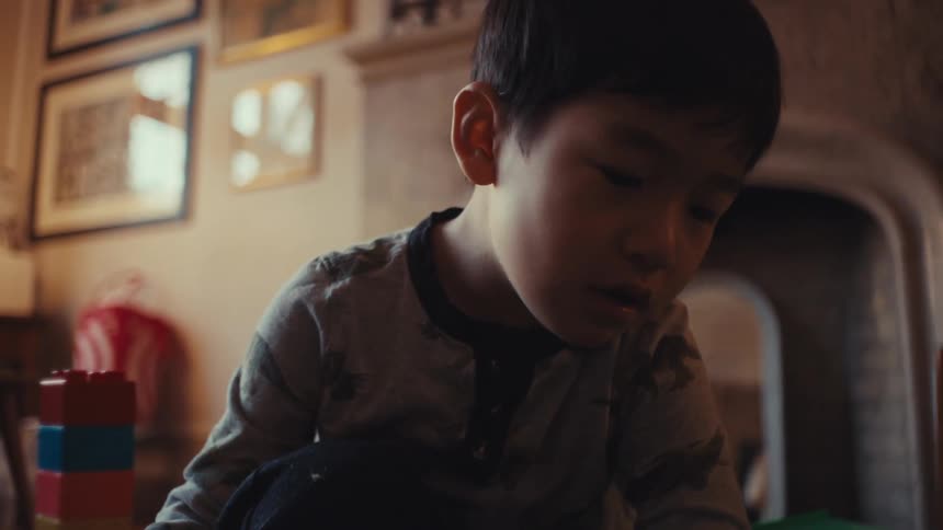 A child is playing with his toys