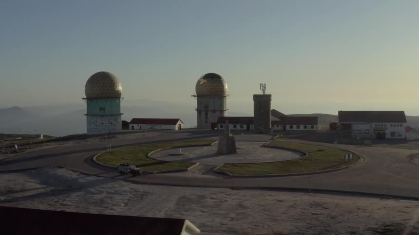 The truck drives past the observatories