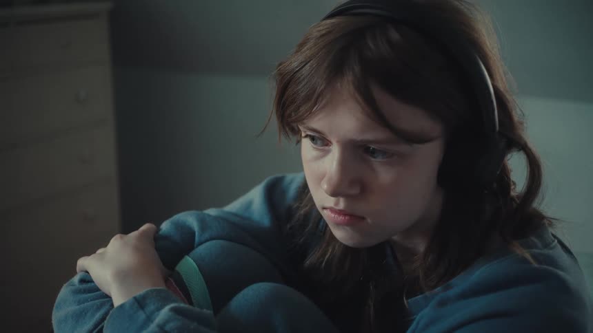 The girl is listening to music on her headphones