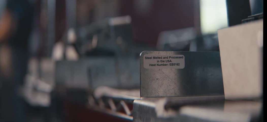The worker picks up a piece of steel in the factory