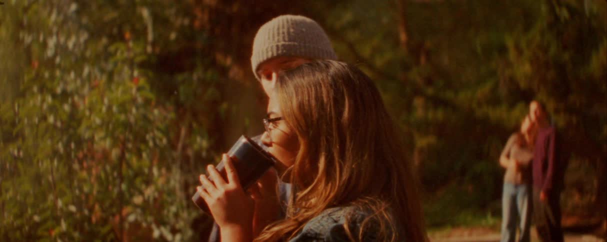 A man touching a womans hair outdoors