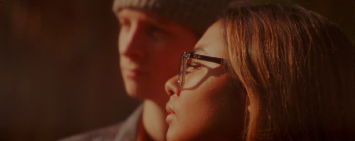 Two young people outdoors at dusk