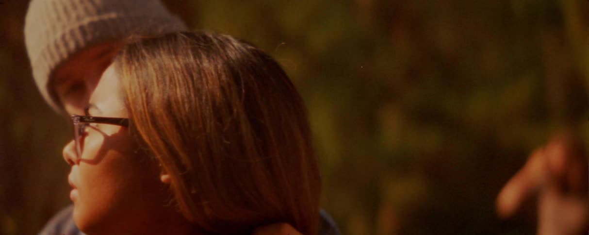The teenager touches the girls hair