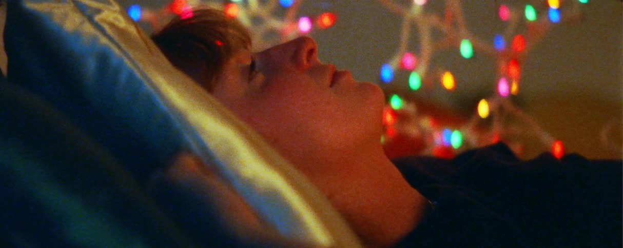Young woman awake and lying in bed