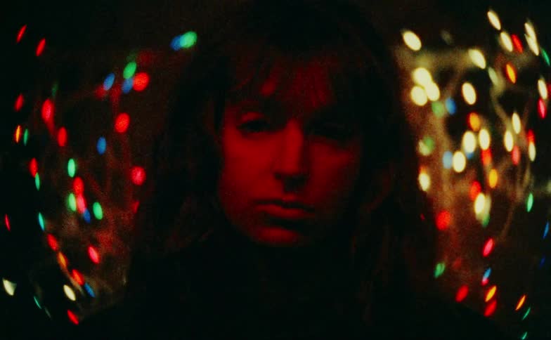 The christmas lights flash on the womans face