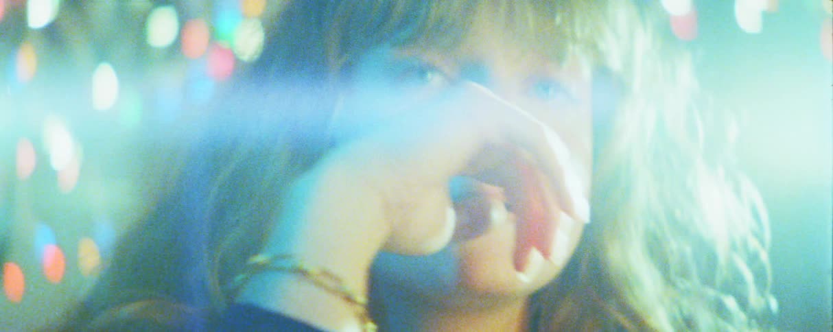 The holiday lights glare on the womans face