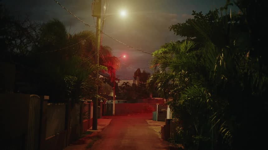 A view of a street in a neighborhood at night