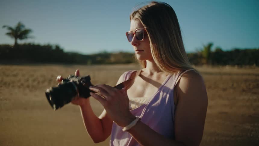 Woman taking photographs in a natural area during the day