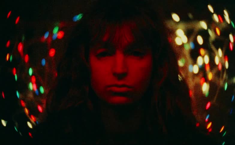 Face of a young woman with blurred colored lights around her
