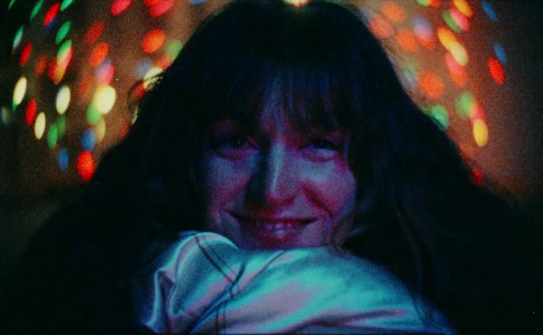 The woman smiles and covers her face
