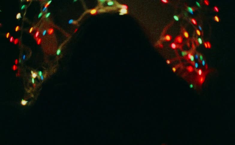 Christmas lights flash on the woman laying down