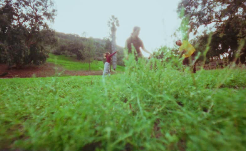 Small group of male and female dancers performing at a park surrounded by trees outdoors during day time