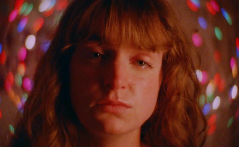 A portrait of a woman with christmas lights around her