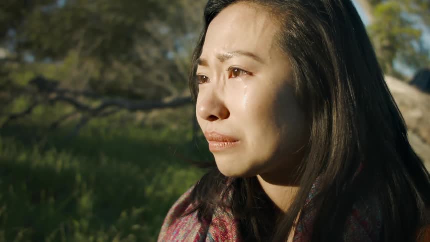 A woman cries and shakes her head
