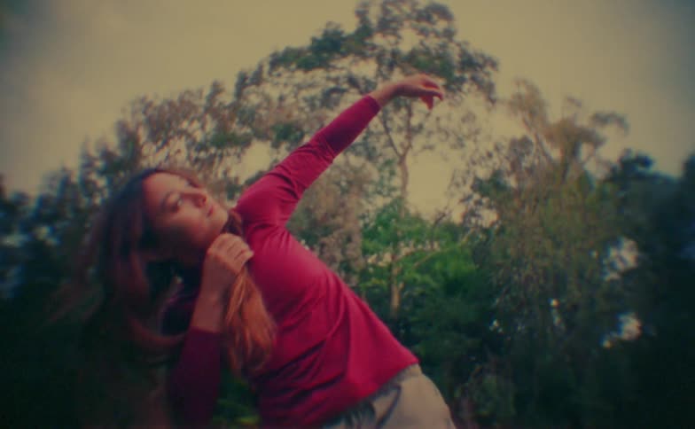 A young woman dancing outdoors during daytime
