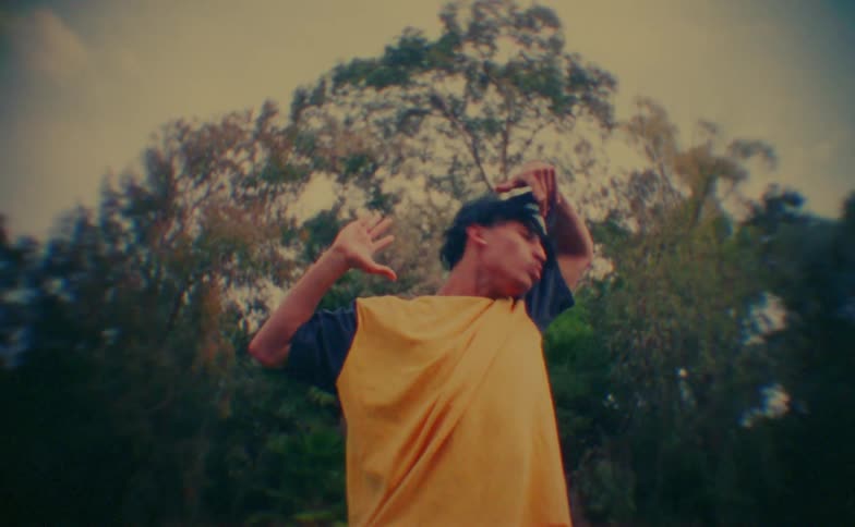 A man dancing outdoors on a sunny day