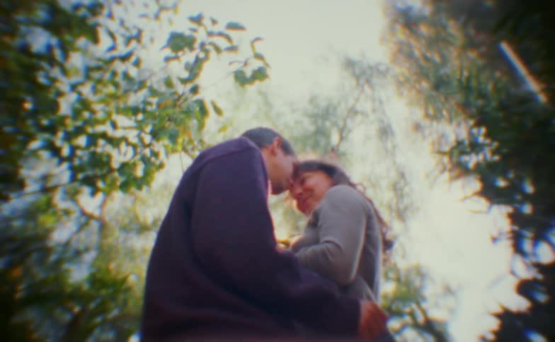 Couple kissing among the trees
