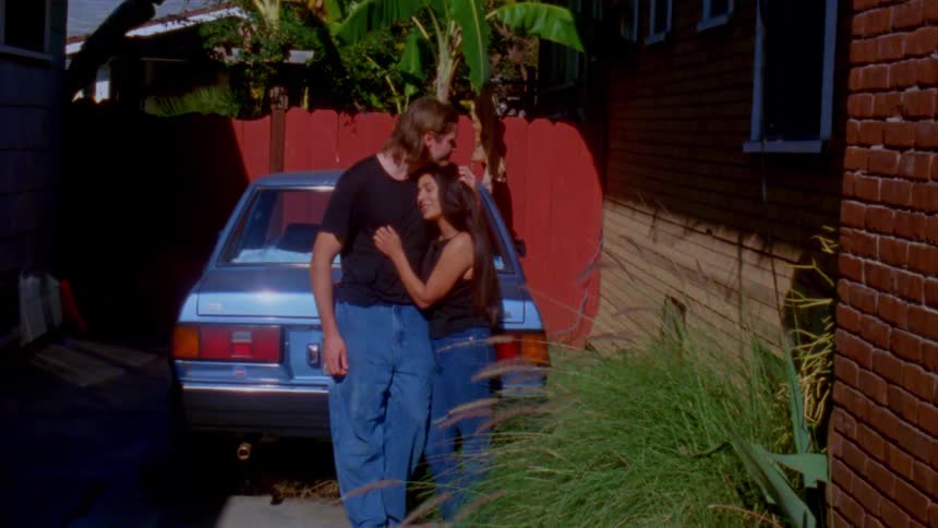 A man and woman hugging each other outdoors