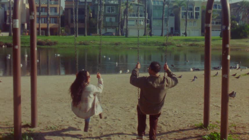 The man and woman swing in the park