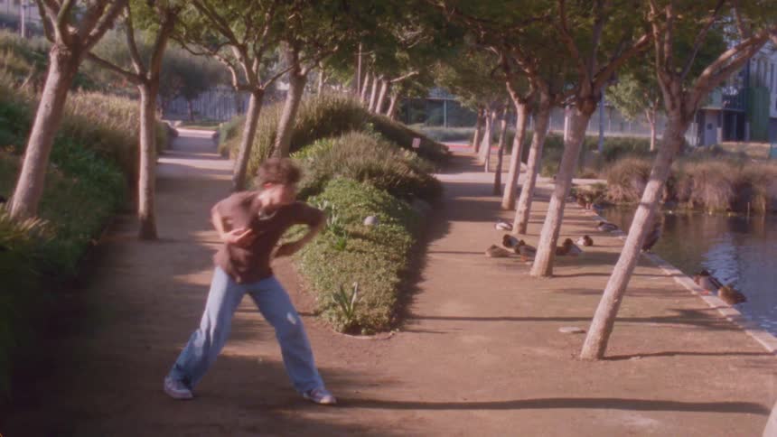 The teenager is dancing in the park