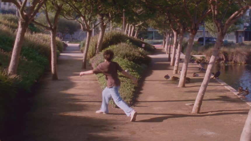 The teenager is dancing by the ducks