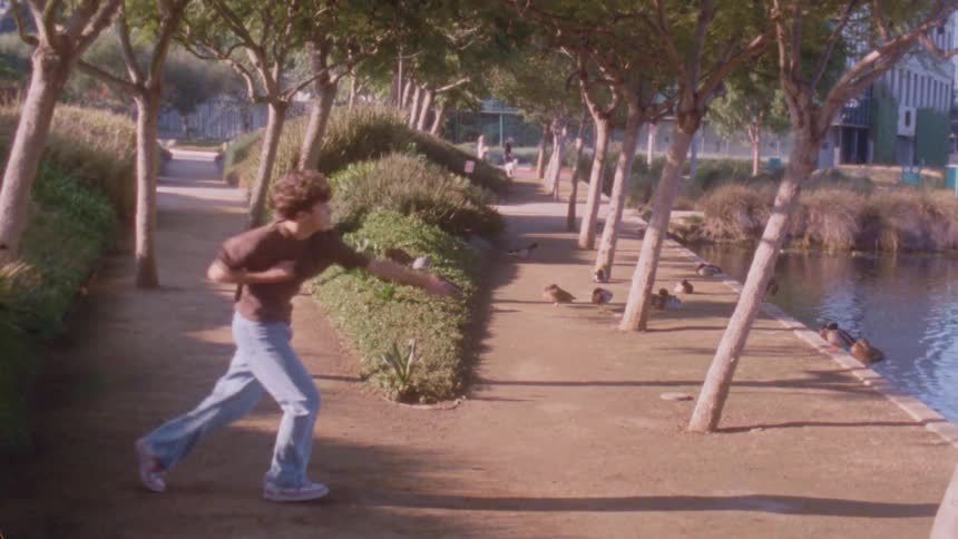 A person dancing outdoors on a sunny day
