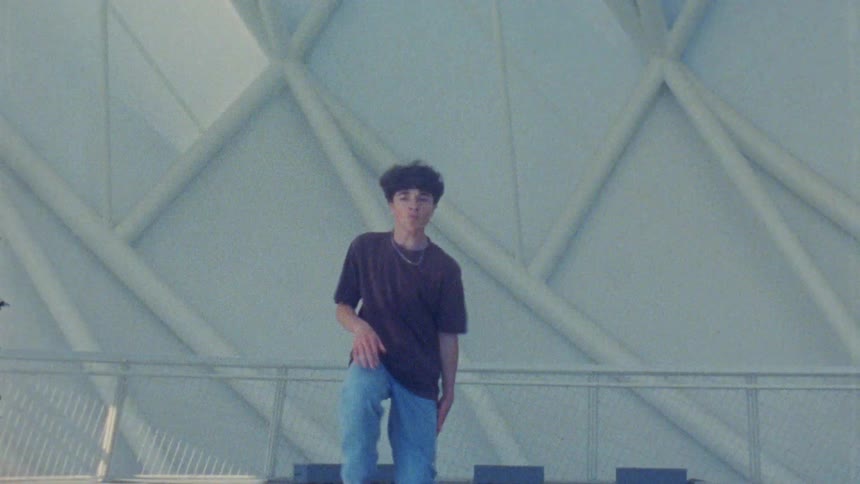 The teenager is dancing by the structure
