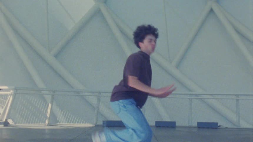 A male teenage dancer dancing outdoors during daytime