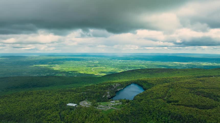 Clouds passing over a relatively flat jungle area outdoors during day time