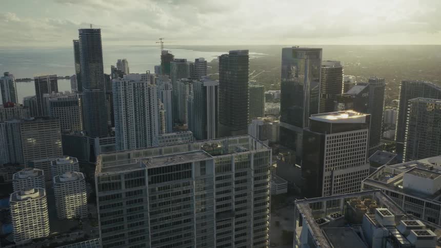 Aerial view of rooftops of downtown buildings and towers along the coast