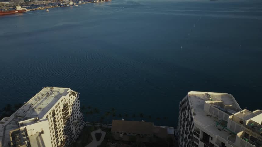 An aerial view of Downtown Miamis skyscrapers at dusk with approaching harbor