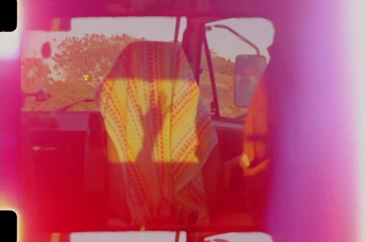 Shadow making a hand gesture on a cloth inside a vehicle