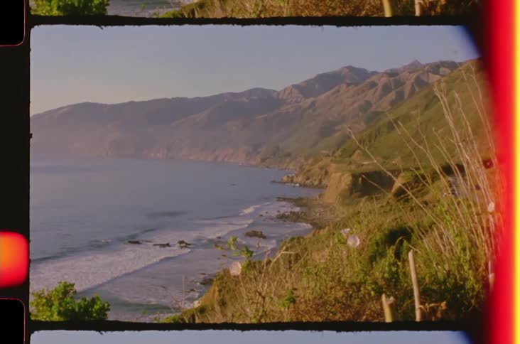 Beach at the coast with the sea to one side and cliffs to the other outdoors during day time