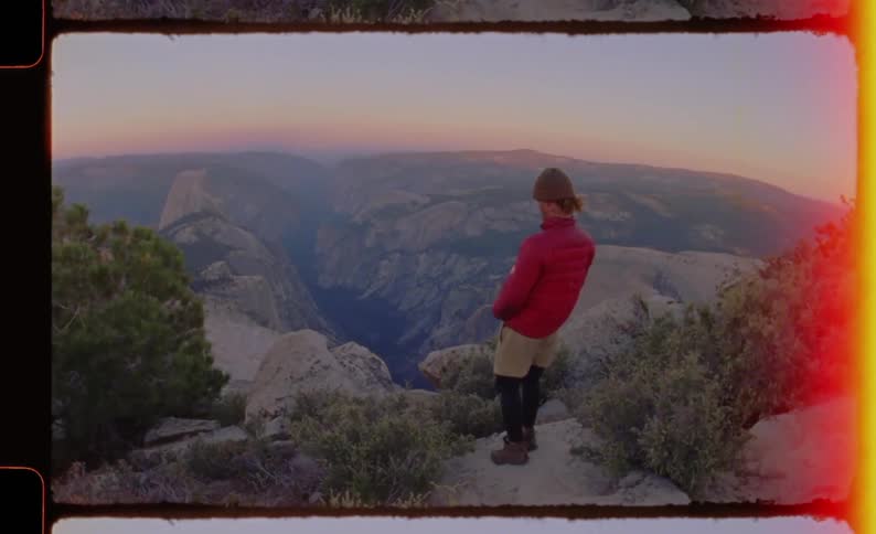 A woman standing at the edge of a cliff