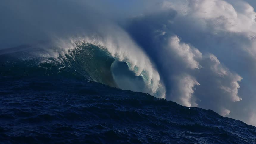 Powerful wave crashing on a blue ocean